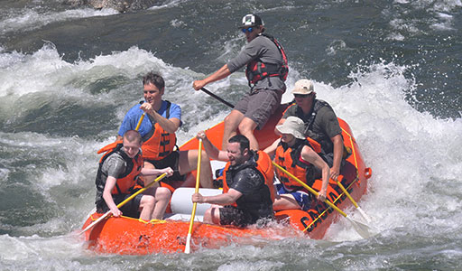The team white water rafting.